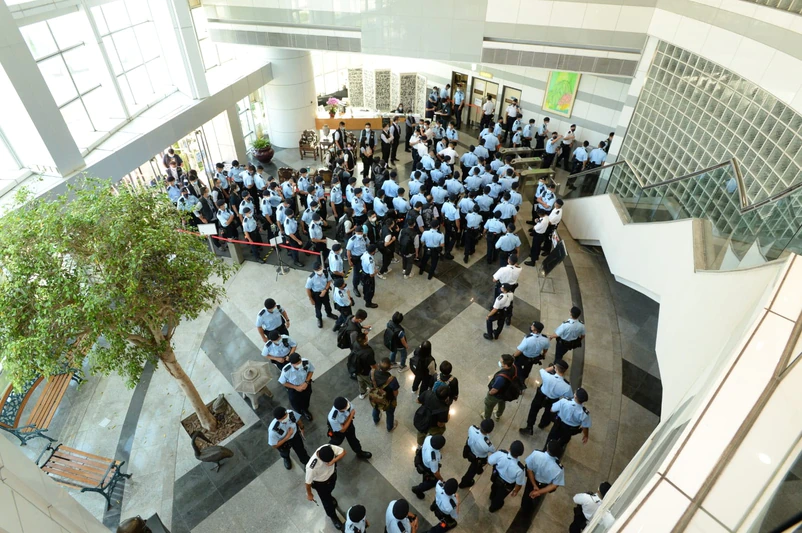 The original photo was taken and published by an Apple Daily reporter four years ago. Photo shows police raid in the Apple Daily Headquaters. 